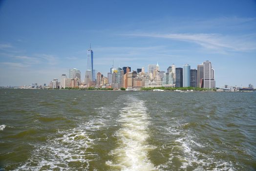 building and skyline of downtown manhattan during daytime as seen from a boat