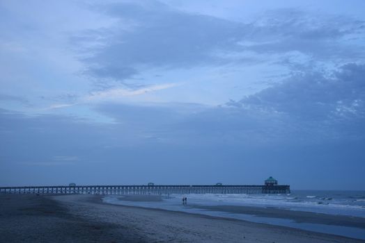 a pier at Folly beach in a cloudy evening