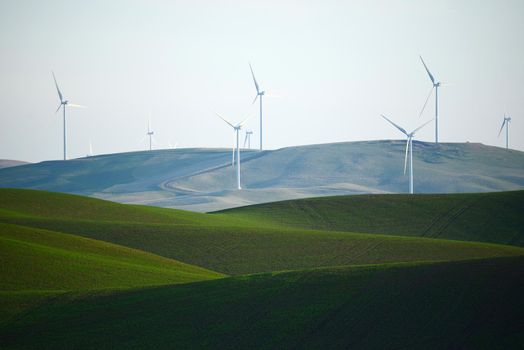 wind mill on green wheat farm hill in palouse, washington