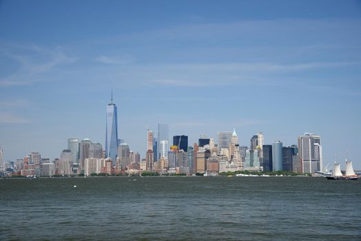 building and skyline of downtown manhattan during daytime as seen from a boat