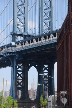 east tower of manhattan bridge framed with old building in brooklyn