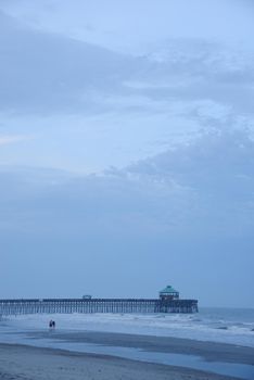 a pier at Folly beach in a cloudy evening