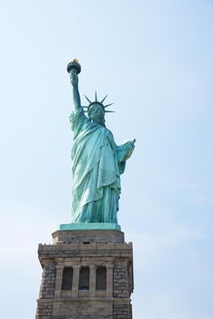 Liberty Statue, a landmark of new york city, with blue sky