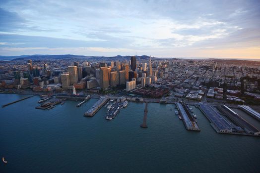 an aerial view of downtown san francisco with pier during sunset