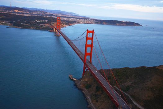 an aerial view of golden gate bridge in san francisco during sunset, taken from a helicopter