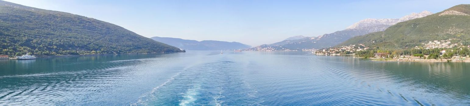 Panoramic view of Bay of Kotor from the sea surrounded by mountains in Montenegro, one of the most beautiful bay in the world.