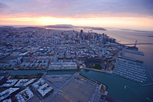 an aerial view of downtown san francisco with pier during sunset