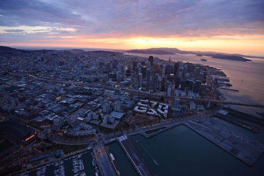 an aerial view of downtown san francisco with pier during sunset