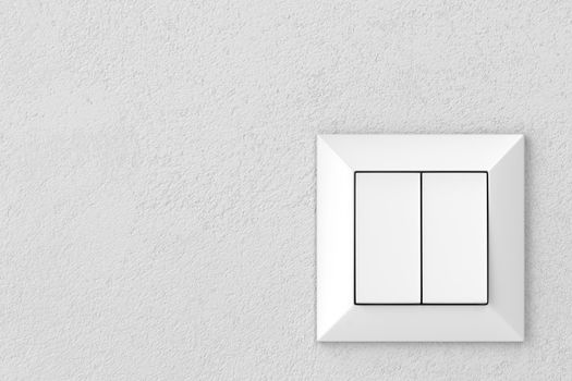 Double light switch on a gray wall, front view