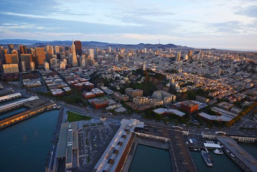 an aerial view of downtown san francisco with pier during sunset