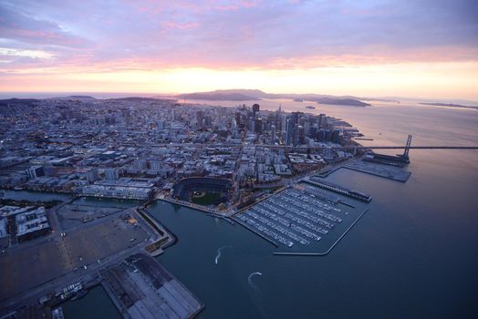 an aerial view of downtown san francisco with pier during sunset