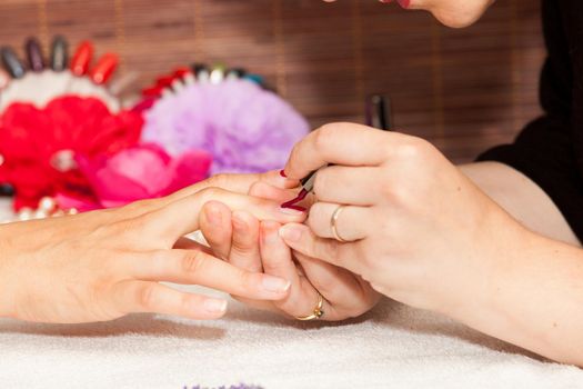 Laying nail polish on a woman's hands