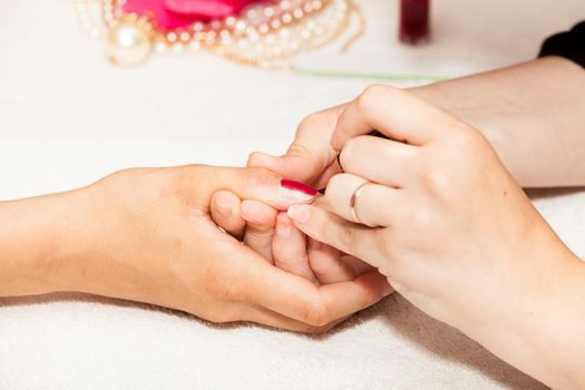 Laying nail polish on a woman's hands