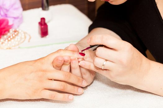 Laying nail polish on a woman's hands