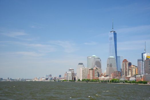 building and skyline of downtown manhattan during daytime as seen from a boat