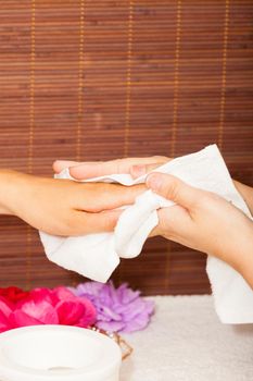 Preparing a woman's hands for a manicure