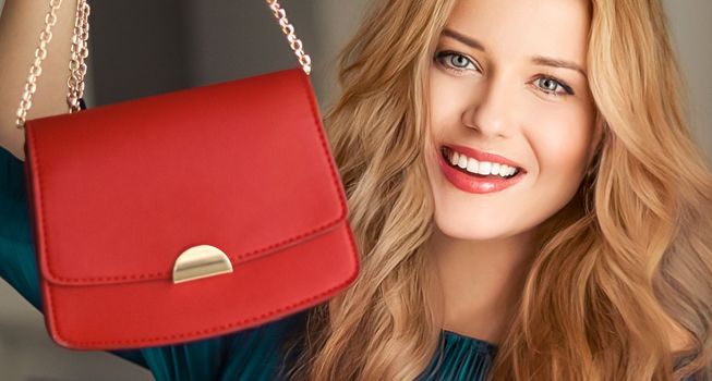 Fashion and accessories, happy beautiful woman holding small red handbag with golden details as stylish accessory and luxury shopping concept