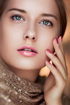 Beauty, makeup and glamour, face portrait of beautiful woman with manicure and pink lipstick make-up wearing gold for luxury cosmetics, style and fashion look
