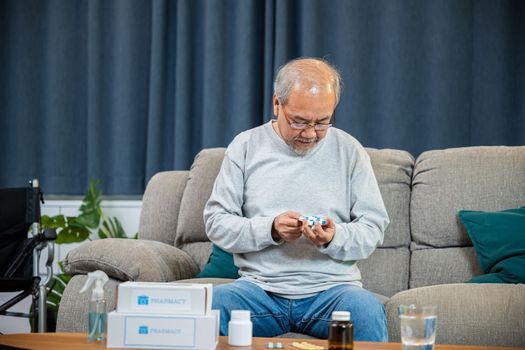 Asian old man buy herbal self cure Rx pill online from pharmacy, worried senior man with medicine pills he read on see how to take pills before taking, home isolation, Medical service concept