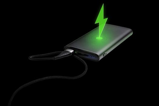Fully charged portable powerbank with cable and two usb outputs isolated on a black background. Powerbank for charging mobile devices. Lightning charging symbol on top, illustration