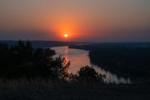 View of river landscape in sunny summer sunset. Top view of siberian Ob river from high attitude in summer sunset.