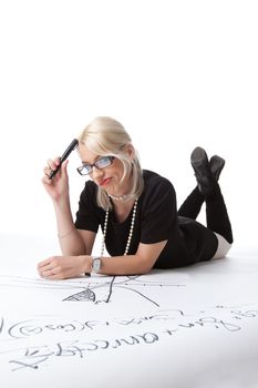 Cute blond woman thinking on drawing graph isolated