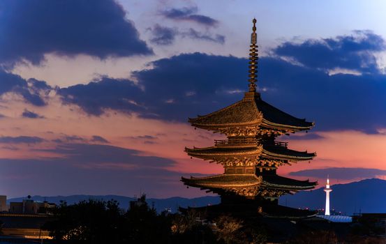 View from Higashiyama of Yasaka Pagoda and distant Kyoto Tower as sun sets. High quality photo