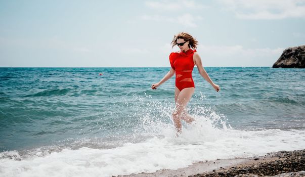 Young happy woman walks carefree on the seaside . Portrait beautiful young woman relax smile around beach sea ocean in holiday vacation travel trip