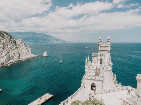 Aerial view of Swallow's Nest castle on the rock in Black Sea. It is a symbol and landmark of Crimea. Beautiful scenic panorama of the Crimea coast. Amazing Swallow's Nest at the precipice.