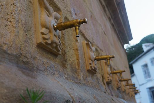 side view of the fountain of the eight spouts in ronda, malaga