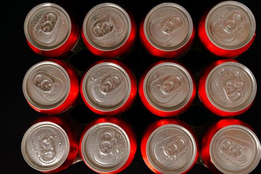 group of beer cans isolated on a black background