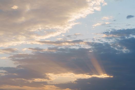 dramatic cloudy skies with sunshine at sunrise