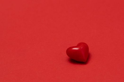 Valentines day red heart on same color background. Monochromatic vivid color. Valentine's day concept. Close up, copy space