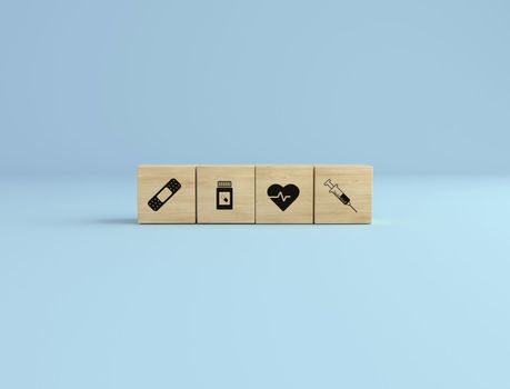 Healthcare concept. Wooden cube block with healthcare icon syringe, health, pills and band on blue studio background. vaccine time.