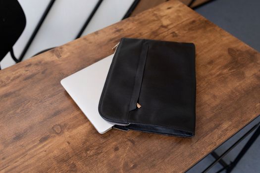 leather folder laptop case on the table.