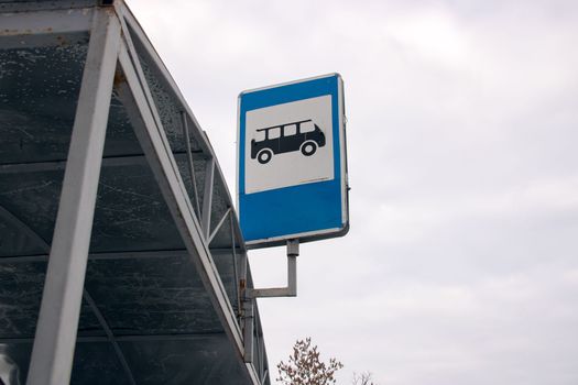 Road sign bus stop on sky background close up