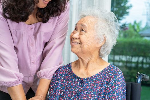 Help and care Asian senior or elderly old lady woman patient sitting on wheelchair at nursing hospital ward, healthy strong medical concept