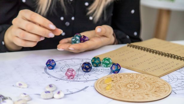 Woman numerologist astrologer counts numbers. Selective focus. People.