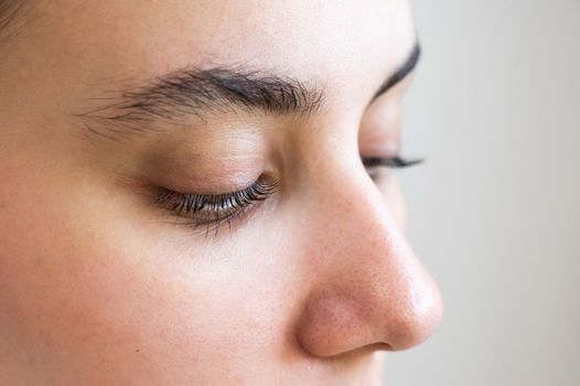 Close-up of a caucasian woman after eyelash lamination procedure