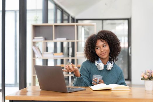 Young asian woman wearing headset working on computer laptop at house. Work at home, Video conference, Video call, Student learning online class..