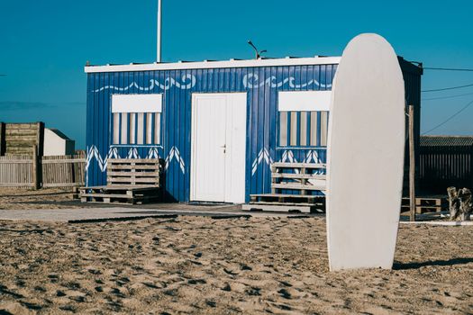 Facade of surf school academy on Portuguese beach at sunset with copy space.