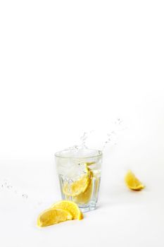 Glass of lemonade with splashing water on white background drink isolated healthy fresh drink concept