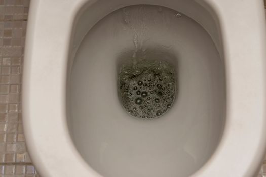 flushing the toilet. Toilet, Flushing Water. close up. High quality photo