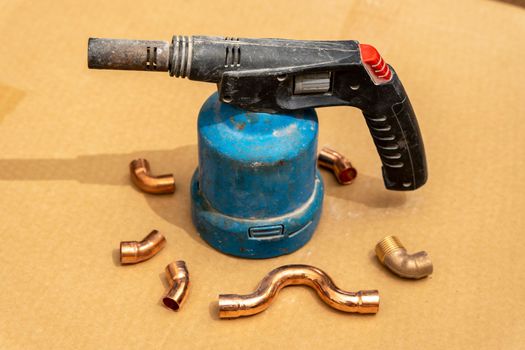 manual gas burner for household purposes for construction. Hand holding gas can with manual torch burner,blowtorch, for soldering copper pipes.