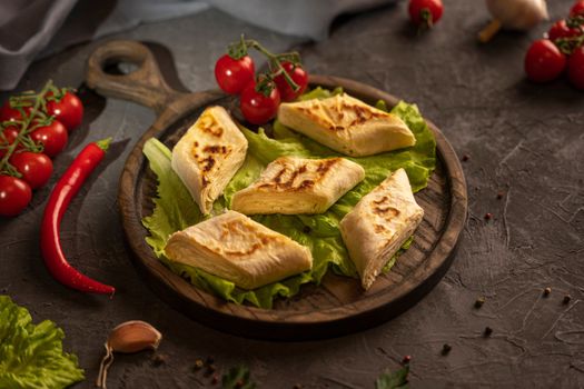 Delicious fried pita bread roll with cottage cheese and herbs. Fried puff rolls of thin Armenian lavash stuffed with cottage cheese. Wrapped tortillas. Traditional cuisine. Delicious and healthy food.