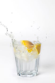 Glass of lemonade with splashing water on white background drink isolated healthy fresh drink concept