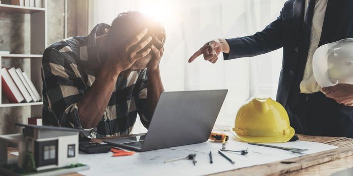 Engineer man stress in work because his boss complaining to him about mistake to manage project in the meeting room at modern office.Mistake project management concept...