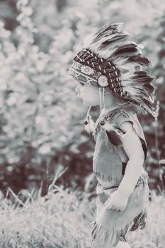 retro photo of adorable child dressed in traditional American clothing.