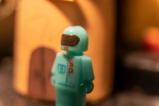 A figure of an astronaut in a space suit and helmet. Space suit. Children's plastic toy. High quality photo