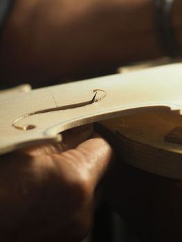 violinmaker cutting and sawing golden period cremonese violin model fholes